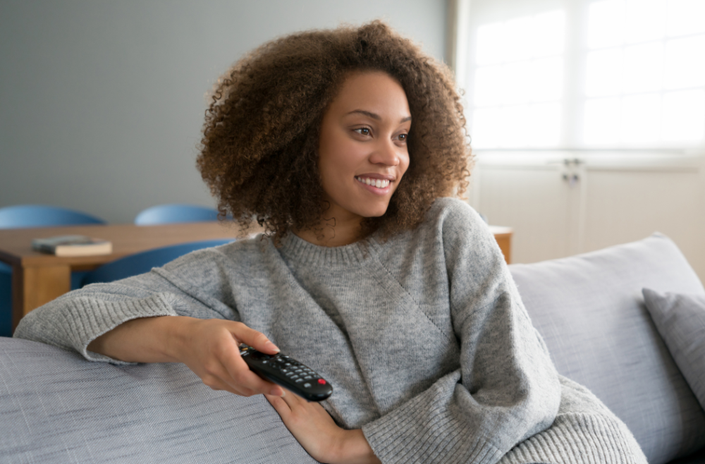 Black mom watching tv for self care idea
